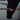 Close-up of a black sleeve with 'Chrome Industries' logo on a blurred background