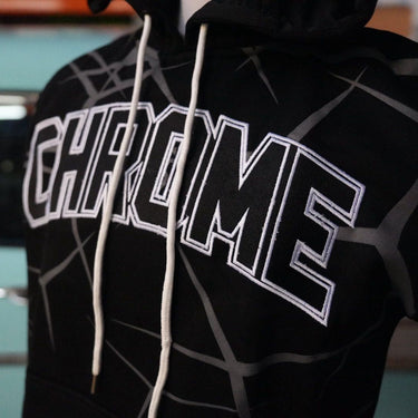 Black hoodie with 'CHROME' text on a blurred background