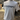 White t-shirt with 'KICKSHIFT' logo on a mannequin in an indoor setting.
